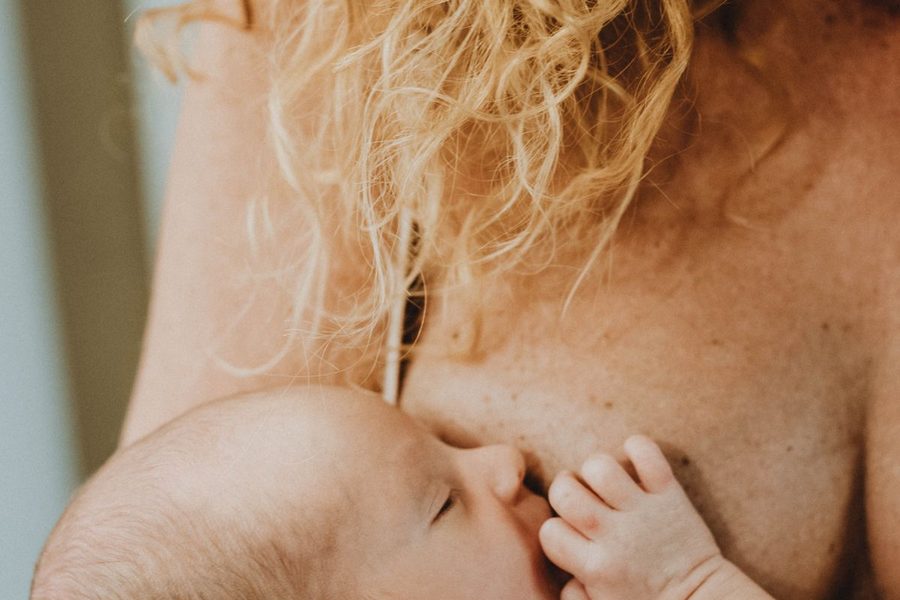 A mother tenderly breastfeeding her newborn